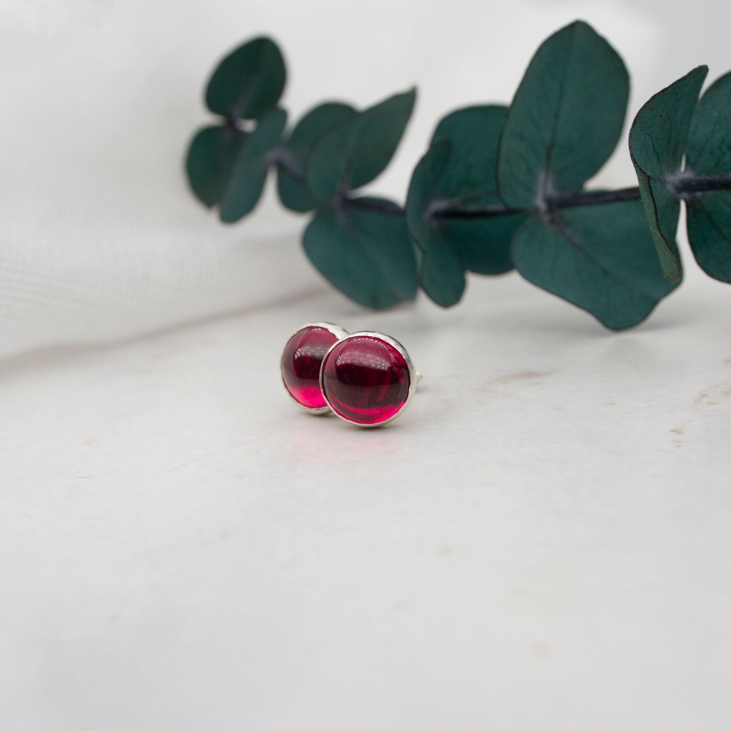 Ruby stud earrings in sterling silver