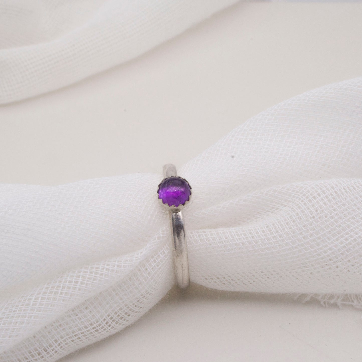 Amethyst 5mm cabochon ring with serrated edge setting- size P