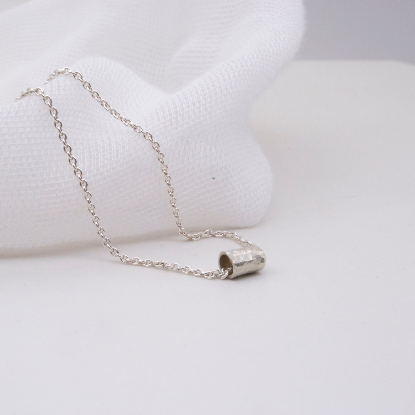 Hammered Silver Tube Necklace – Minimal with a Twist