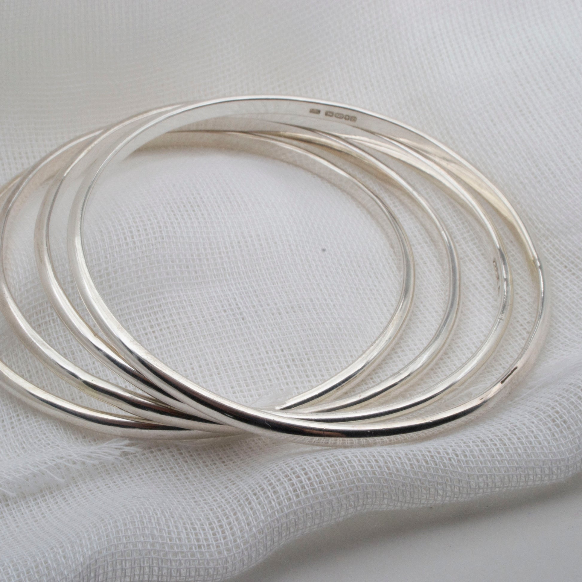 simpler sterling silver bangles in a pile