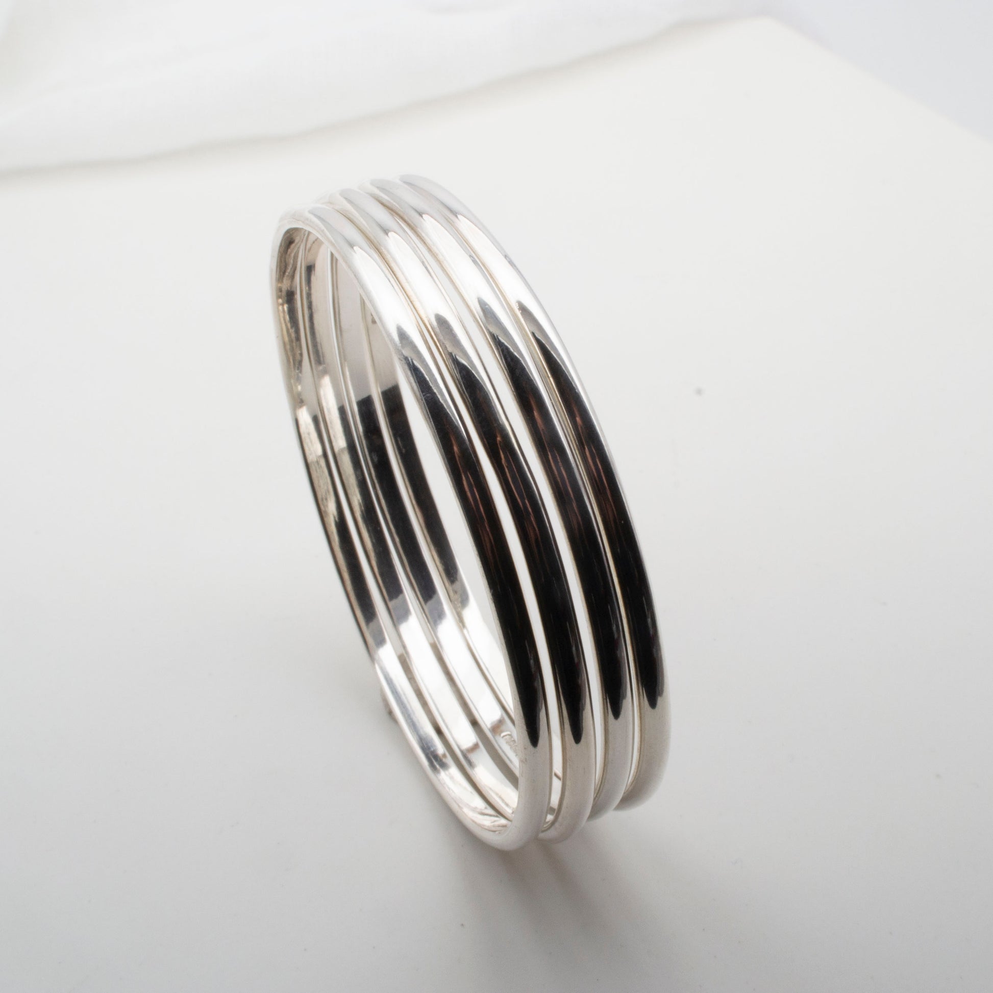 stack of 4 sterling silver bangles