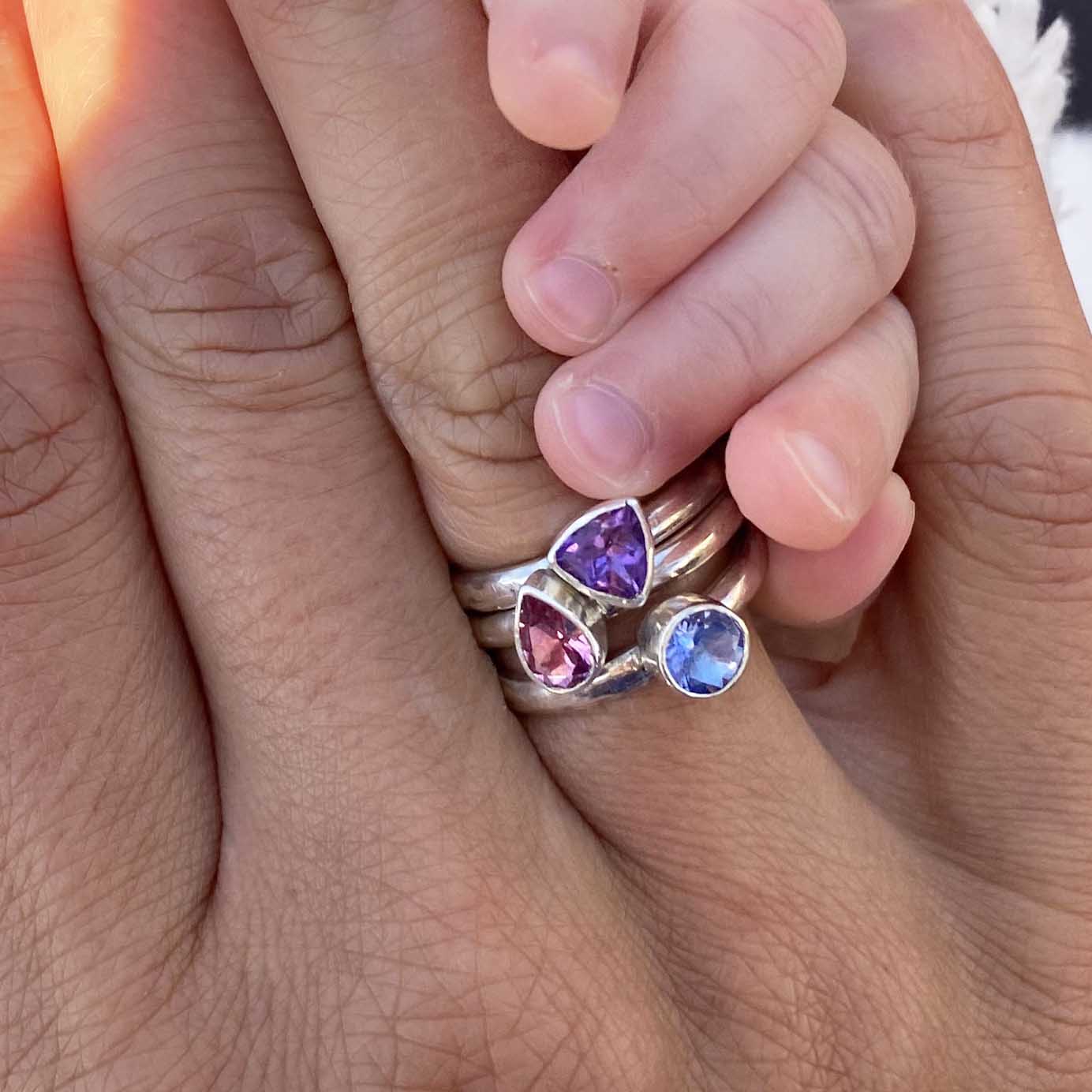 birthstone stacking ring set on fingers