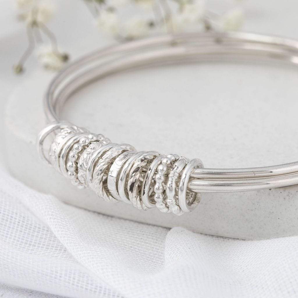 silver interlinked bangles with silver charms